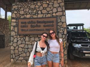 two women standing in front of a stone wall at Tranquil Sanctuary Yala in Tissamaharama +144 photos
