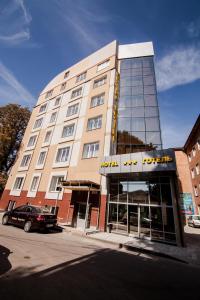 a hotel building with a car parked in front of it at Optima Rivne in Rivne