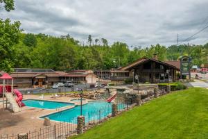 a resort with a swimming pool and a playground at Brookside Lodge - Gatlinburg - On the River in Gatlinburg