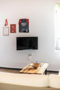 a coffee table in a living room with a tv at Rock Solid Stone House - Chora Samothraki in Samothraki