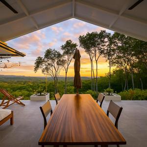 a dining room with a table and a view of the sunset at Amazing Oceanview Villa with Private Pool - Fast WiFi in Ojochal
