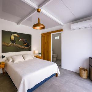 a bedroom with a large bed and a bathroom at Amazing Oceanview Villa with Private Pool - Fast WiFi in Ojochal