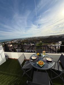 a table with a bowl of fruit on a balcony at Apartamento Florkin vacacional acogedor recién reformado con vistas al mar in Torrox