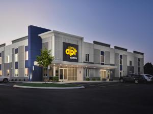 a building with a sign for a car dealership at stayAPT Suites Chattanooga-Ooltewah/VW in Ooltewah