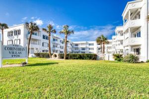 una señal frente a un gran edificio con palmeras en Oceanfront Elysium with a pool, en Ormond Beach