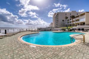 a swimming pool with a view of the ocean at Paradise on the beach with pool in Daytona Beach