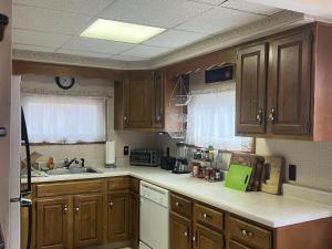 Una cocina con gabinetes de madera y un fregadero. en Cozy Catskill Mountain Cabin, en Margaretville 16 fotos más