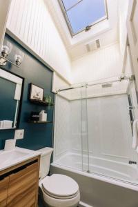 a bathroom with a shower and a toilet and a sink at Catskills Arthouse - 15 mins to Skiing in Margaretville