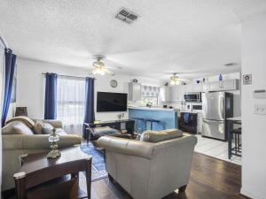 a living room with two couches and a kitchen at Spacious Stay, Family Comfort, Quiet Escape in Plant City