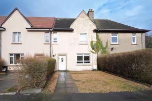 a white house with a driveway in front of it at Barassie Villa located near Troon in Troon
