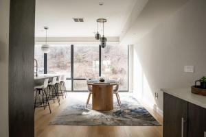 a kitchen with a table in the middle of a room at Chic Luxury 4BR Townhome with NYC Views in North Bergen