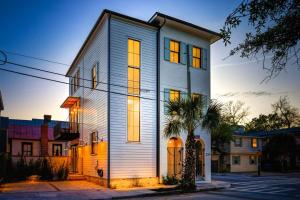 a house on a street with the sun shining on it at 259 St Philip in Charleston