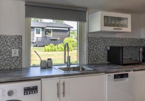 a kitchen counter with a sink and a window at Hjärnarp in Hjärnarp