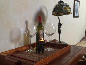a table with a bottle of wine and two wine glasses at B&B Tra Mare e Laguna in Venice-Lido