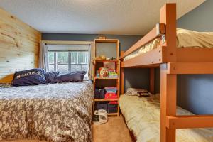 a bedroom with a bunk bed and a ladder at Silverthorne Condo with Lake Views 10 Mi to Skiing! in Silverthorne