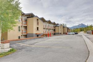 a parking lot with a row of apartment buildings at Silverthorne Condo with Lake Views 10 Mi to Skiing! in Silverthorne
