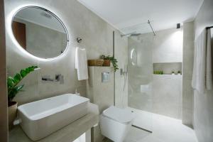 a bathroom with a sink and a toilet and a mirror at La casa sull' isola in Zakynthos Town