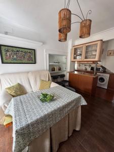 a living room with a table and a couch at Alcalá zona centro duplex in Alcalá la Real +28 photos