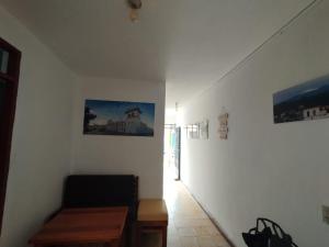 a room with a table and pictures on the wall at Welcome Home Cali in Cali
