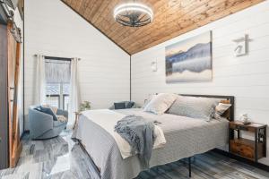 a bedroom with a bed and a cross on the wall at Life's Good Retreat Main House in Brevard +33 photos
