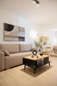 a living room with a couch and a coffee table at Casa Moderna in Fourfourás