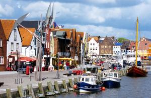 two boats are docked at a marina in a city at Altstadtflair Apartment in Husum
