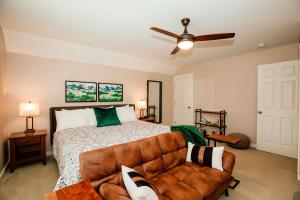a bedroom with a bed and a couch at 1 Mi to Dtwn Black Mountain Home with Patio and Yard in Black Mountain
