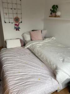 a large bed sitting in a room with at Modern & Cozy Apartment near Tomorrowland- Sleeps 4 in Edegem
