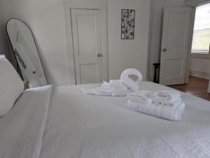 a white bed with two folded towels on it at New! Renovated 2br1ba Near Ncssm in Durham +26 photos