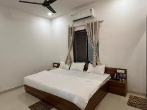 KhātuHotel Shri Raghuvansh的带床和吊扇的卧室