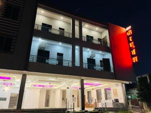 KhātuHotel Shri Raghuvansh的一座前面有霓虹灯的建筑物