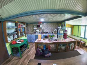 a kitchen with a counter in the middle of a room at Sisney River Retreat in Rongli