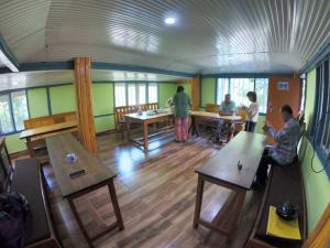 a group of people in a room with tables at Sisney River Retreat in Rongli