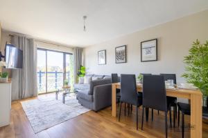 a living room with a table and a couch at Belfast Quarters Riverside in Belfast