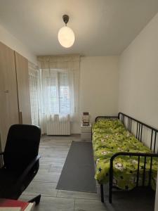 a bedroom with a bed and a chair in it at Emanuele Home in Rho