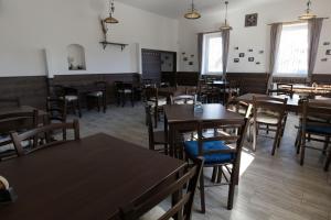 a dining room with wooden tables and chairs at Penzion a restaurace U Jágrů in Kladno