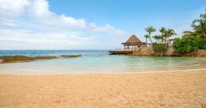 a beach with a gazebo and the ocean at Grand Park Royal Cozumel - All Inclusive in Cozumel