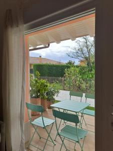 a patio with a table and chairs on a deck at La Alegria de la Huerta Cudillero in Cudillero