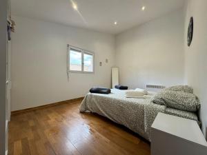 a bedroom with a bed and a window at Chez Zelie in Canet-en-Roussillon