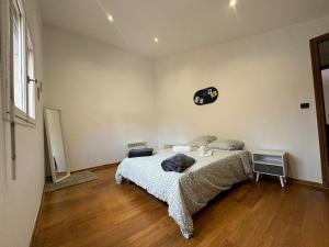 a bedroom with a bed and a clock on the wall at Chez Zelie in Canet-en-Roussillon +2 photos