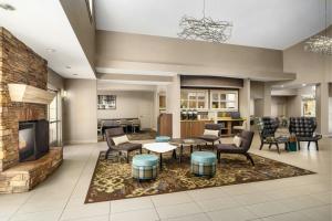 a lobby with a living room with chairs and a fireplace at Residence Inn By Marriott Las Vegas Stadium Area in Las Vegas
