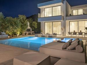 a house with a swimming pool in front of a house at The White Luxury Villa - Private Seaview Villa with Pool by Villa Mana Gers in Vasilikos