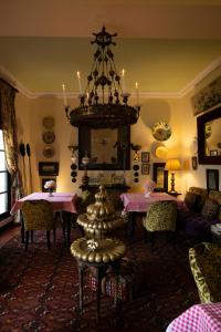 a living room with two tables and a chandelier at Aux 3 Portes in Tangier