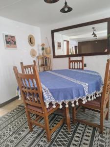 a dining room with a table and two chairs at EL LIMÓN departamento in Oaxaca City +13 photos
