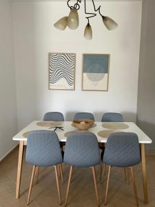 a dining room with a table and chairs at Nicol's Sweet Home in Asprovalta