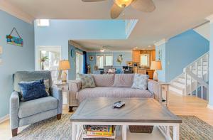 a living room with a couch and a table at Dolphin Run by Carolina Beach Realty in Kure Beach