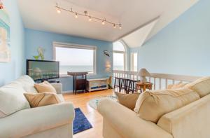 a living room with two couches and a television at Dolphin Run by Carolina Beach Realty in Kure Beach