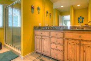 a bathroom with a double sink and a shower at Dolphin Run by Carolina Beach Realty in Kure Beach