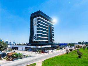 a tall black building with a parking lot in front of it at RENEX HOTELS in Antalya