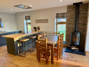a kitchen with a wooden table and a stove at Ribble Valley Hideaways in Preston